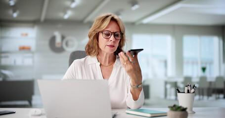 Professional Woman Juggling Calls And Computer Tasks
