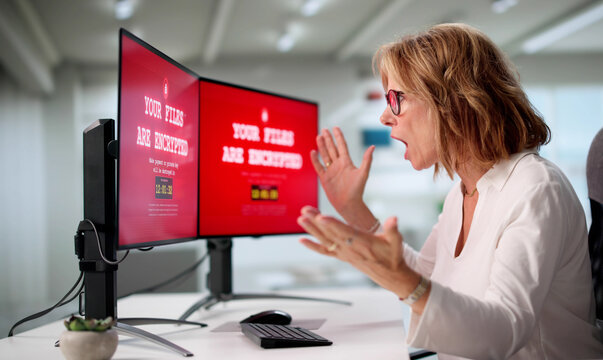 Senior Woman At Home Worried About Cyber Security Breach