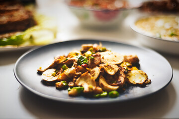 Saut��ed Mushrooms with Peas and Crispy Toppings on a Plate