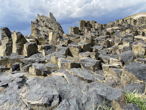 Rugged Basalt Rock Formations Under a Cloudy Sky