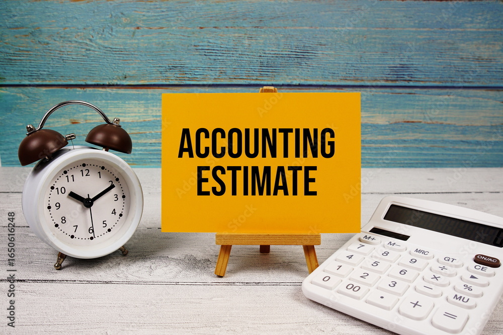 Poster accounting estimate text written on paper card with calculator and alarm clock on wooden background