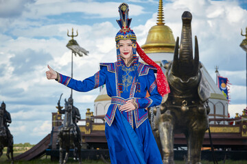 Mongolian girls dressed in luxurious Mongolian costumes on the Mongolian war chariots of the...