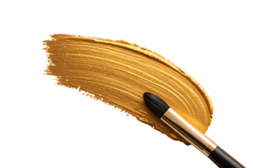 Golden paint brush stroke with metallic bristles creating artistic curved pattern on white surface, isolated on a transparent background