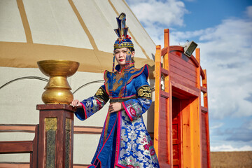 Mongolian girls dressed in luxurious Mongolian costumes on the Mongolian war chariots of the Jinyuan Grand Tent on the grassland