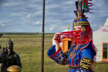 Mongolian girls dressed in luxurious Mongolian costumes on the Mongolian war chariots of the Jinyuan Grand Tent on the grassland