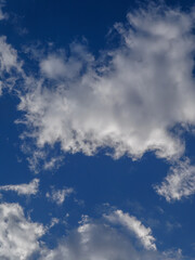 Bright blue sky with fluffy white clouds.