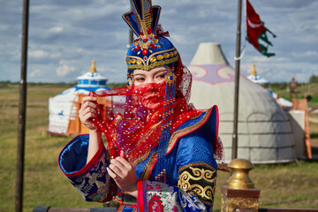 Mongolian girls dressed in luxurious Mongolian costumes on the Mongolian war chariots of the Jinyuan Grand Tent on the grassland