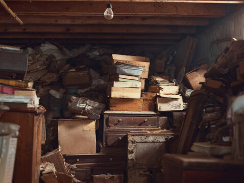 An old, cluttered attic filled with boxes, furniture, and memories. Evokes feelings of nostalgia, hoarding, and forgotten history. - Powered by Adobe