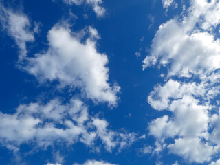 Deep Blue Sky with Scattered White Clouds
