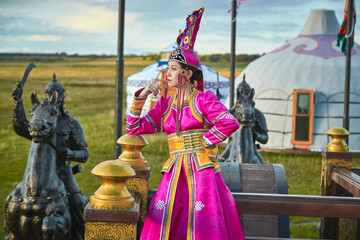 Obraz premium Mongolian girls dressed in luxurious Mongolian costumes on the Mongolian war chariots of the Jinyuan Grand Tent on the grassland