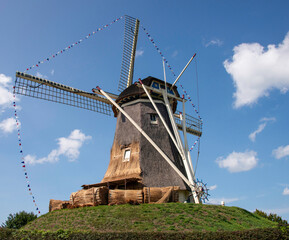 Dutch Wind Mills vintage type with blue sky background.
