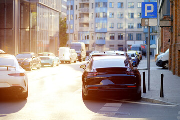 Luxury Cars Parked With Violation on City Street in Paid Parking Zone at Sunset