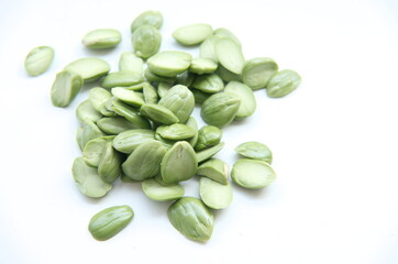 A collection of fresh, peeled petai seeds, a popular ingredient in spicy Indonesian cuisine and a...