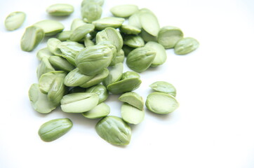A collection of fresh, peeled petai seeds, a popular ingredient in spicy Indonesian cuisine and a...