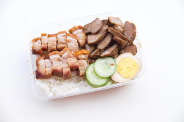 A delicious takeout meal featuring crispy roasted pork, savory braised meat, and a side of fresh...