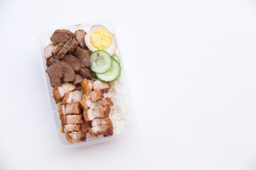 A delicious takeout meal featuring crispy roasted pork, savory braised meat, and a side of fresh...