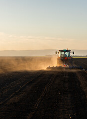 Fototapeta premium Tractor preparing the land for a new crop planting