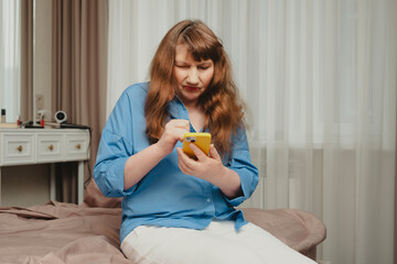 Beautiful old woman chatting on smartphone, placing order online or reading social networks in...