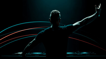 Silhouette of male DJ in black t-shirt facing crowd, arm raised, colorful arcs of cyan and red lights above booth, dark concert setting
