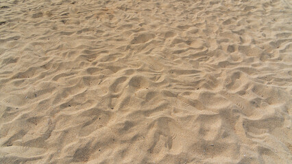 Texture of light brown beach sand,  An abstract representation of beach sand is presented, with...