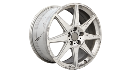 A damaged and worn alloy car wheel rim with scratches, isolated on transparent background