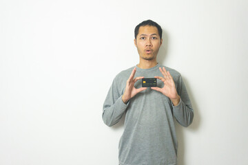 young Adult Asian men wearing grey shirt showing credit card isolated white background
