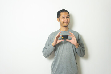 young Adult Asian men wearing grey shirt showing credit card isolated white background