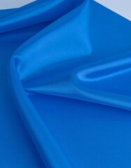 Smooth, vibrant blue fabric drapes