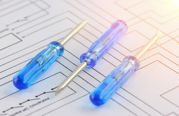 Screwdrivers with an insulated handle on an electronic digram during the assembly of an electrical...