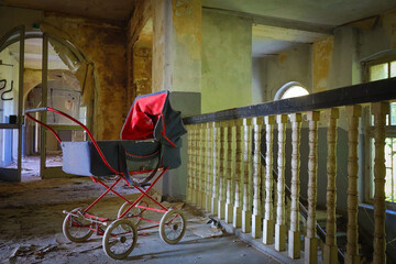 old retro stroller in an abandoned children's home