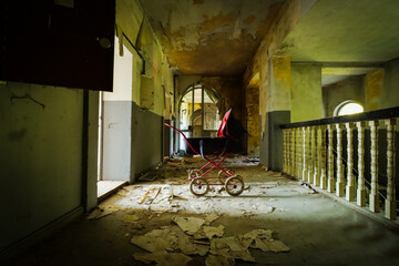 old retro stroller in an abandoned children's home