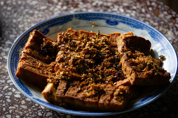 Vietnamese traditional vegetarian dish of fried tofu with lemongrass and chili, served on a classic...