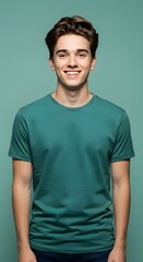 Obraz premium Smiling Young Man Portrait in Teal T-Shirt on Green Background
