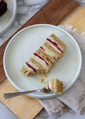 top view of  elegant dessert plate with pistacchio raspberry cake slice