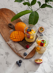 Top view of two  jars with mango and passionfruit smoothie