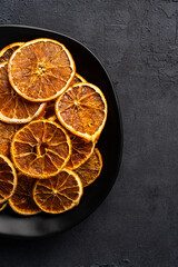 Dried orange slices on black  background.