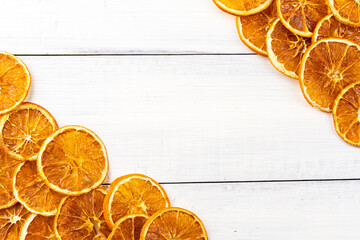 Dried  orange slices on white wood background.