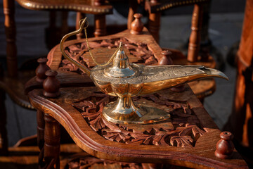 Ornate Brass Oil Lamp on Intricate Wooden Table