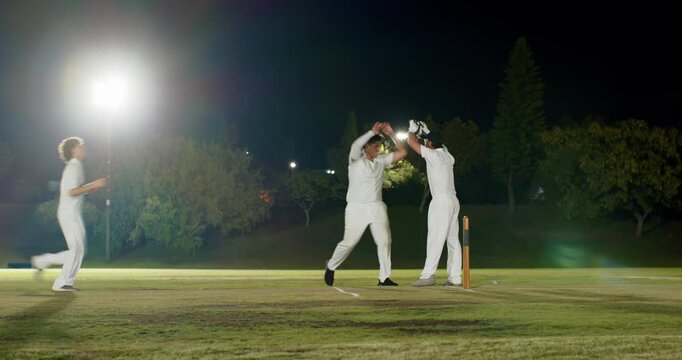 Indian batter sprinting after shot sparking fielder breaking stumps male trio cheering at night