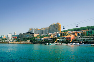 Colorful waterfront buildings, modern hotels, and cable cars over the turquoise sea in Phu Quoc, Vietnam