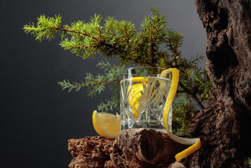 Hard seltzer with lemon in a crystal glass on an old board.