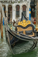 Traditional Venetian gondolas with ornate seats in Venice, Italy