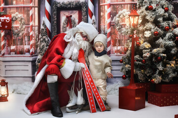 Cute little boy with Santa Claus at Christmas