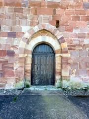 Wooden arched doorway of San Juan Bautista Church in Nogales de Pisuerga, Palencia
