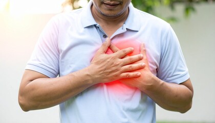 Chest Pain - Close Up of Person Holding Chest with Red Glow Symbolizing Pain