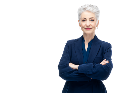 Confident businesswoman with gray hair standing with arms crossed in a stylish outfit against a plain background