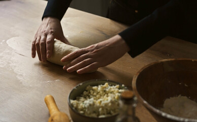 Shaping dough by hand on kitchen counter.