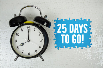 25 Days To Go! text with alarm clock on blue background