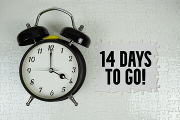14 Days To Go! text with alarm clock on white background