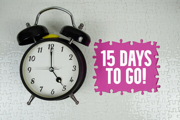 15 Days To Go! text with alarm clock on pink background